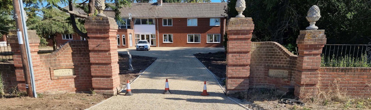 This is a photo of a newly installed chip and tar driveway, installed by Isleham Driveways